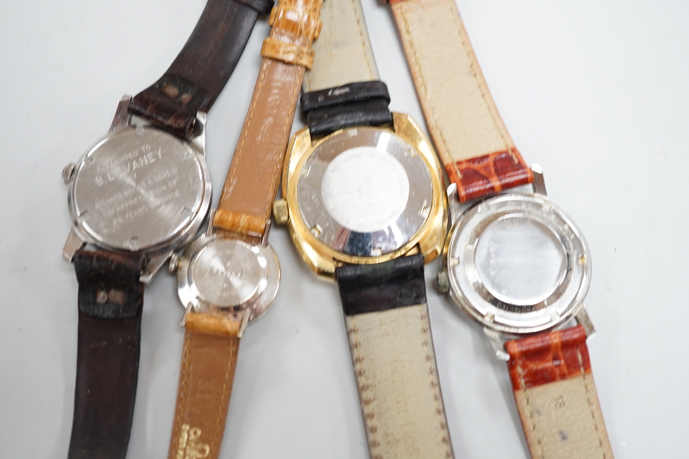 Three assorted gentleman's steel or gilt wrist watches, including retailed by Buhre and a lady's steel manual wind Bulova watch.